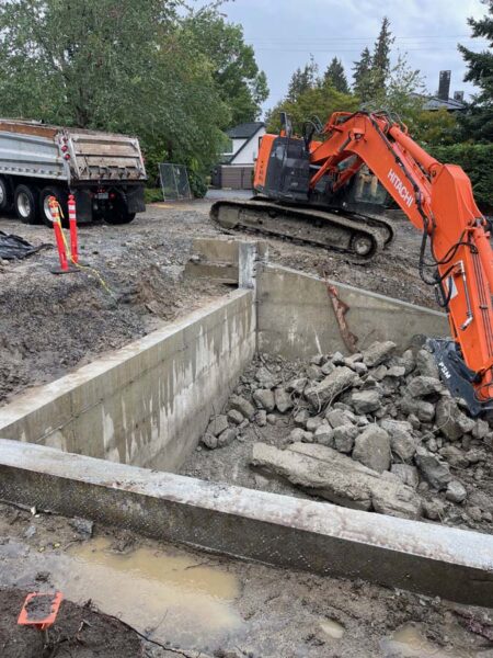 Excavator clearing debris at construction site