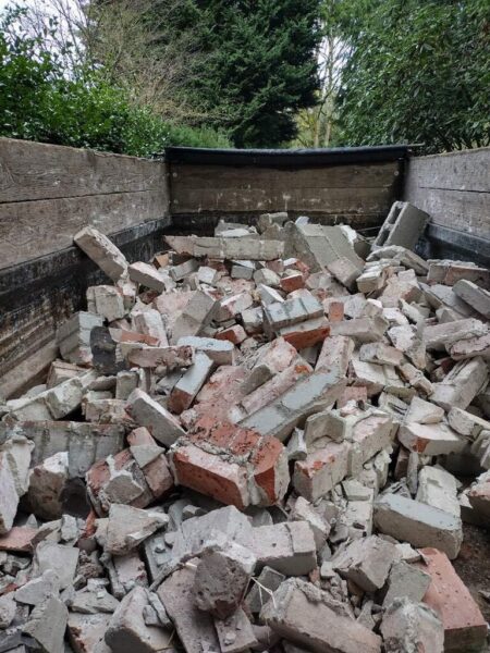 Truck bed filled with broken bricks and debris