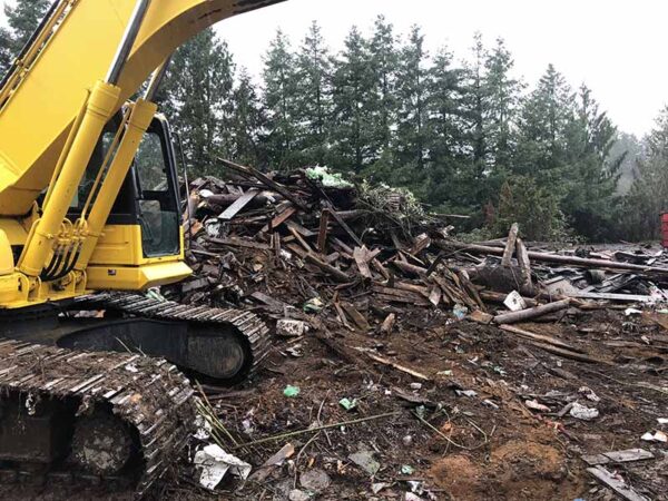 Excavator clearing debris of a demolition job in the Washington area