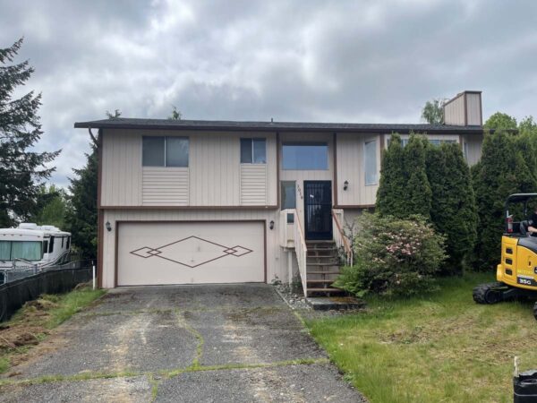 Residential house with beige siding and garage