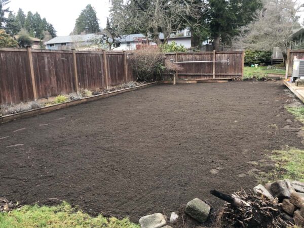 Freshly tilled soil in residential backyard garden