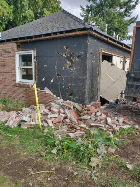 Damaged house with broken bricks and exposed structure