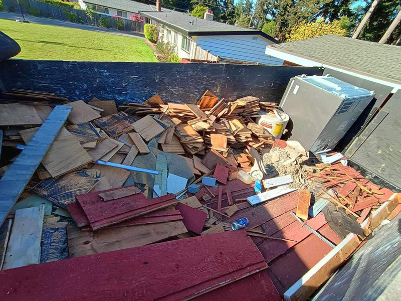 Dumpster filled with construction debris and discarded materials