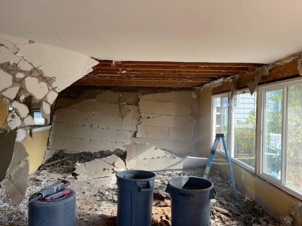 Damaged room interior undergoing renovation with debris