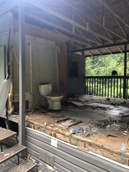 Dilapidated bathroom in abandoned outdoor structure