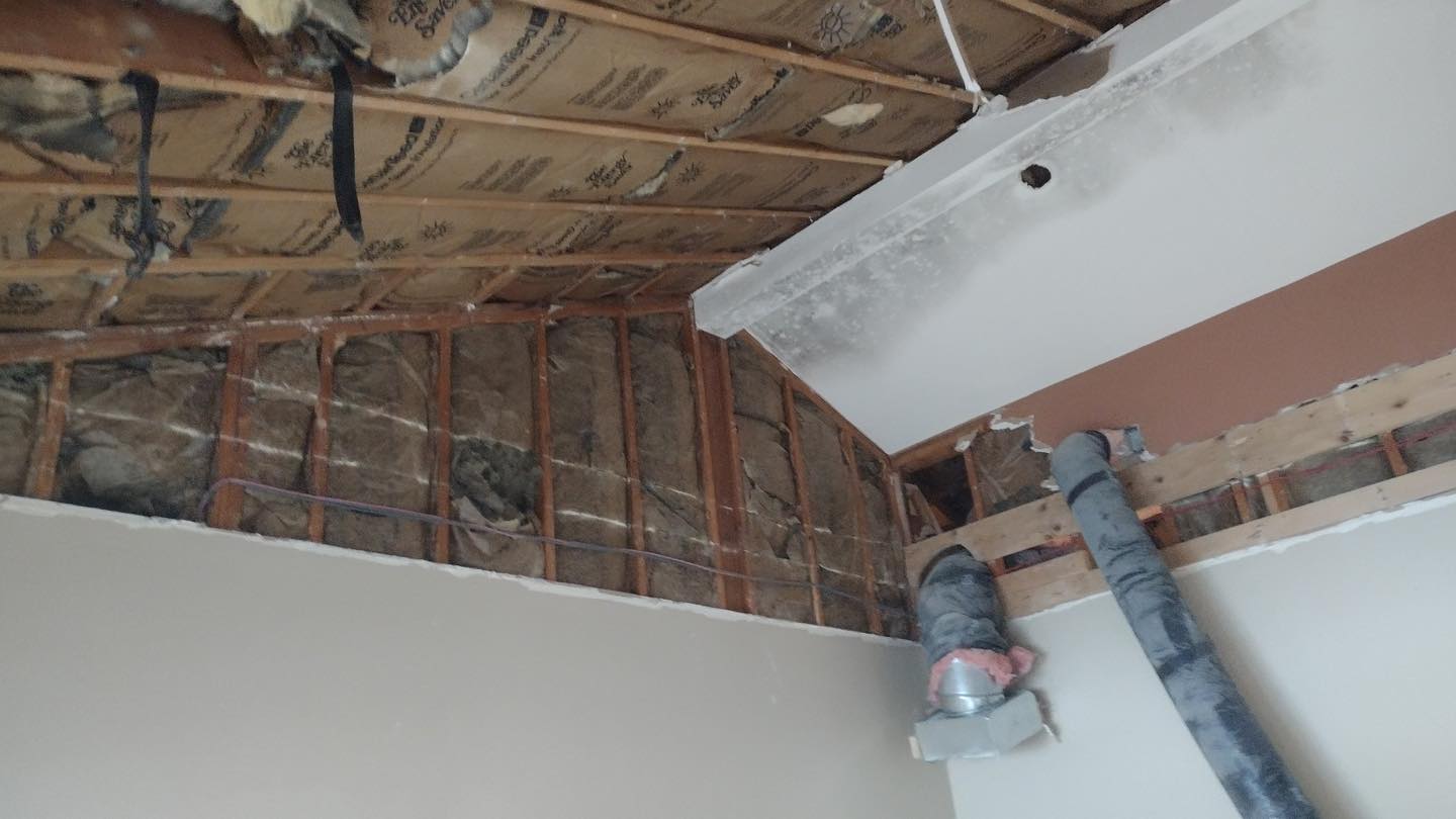 Exposed ceiling with insulation and framing in renovation