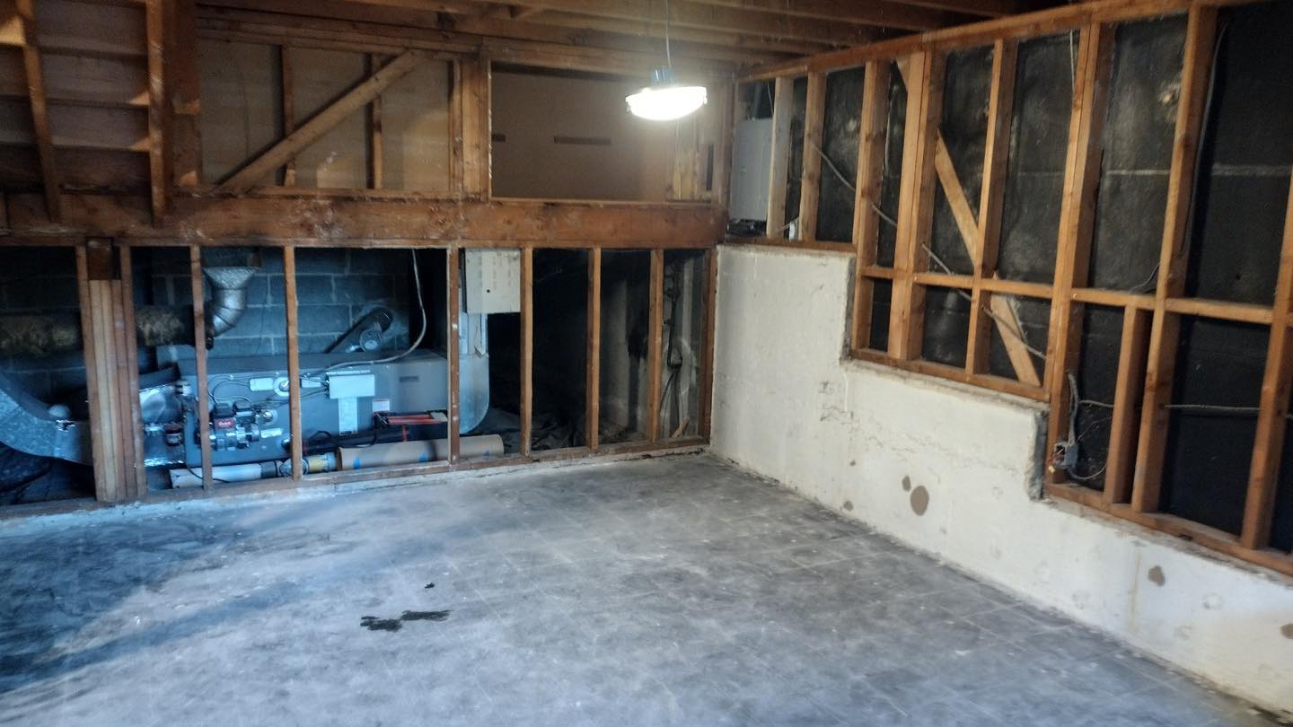 Unfinished garage interior exposing wooden studs and insulation