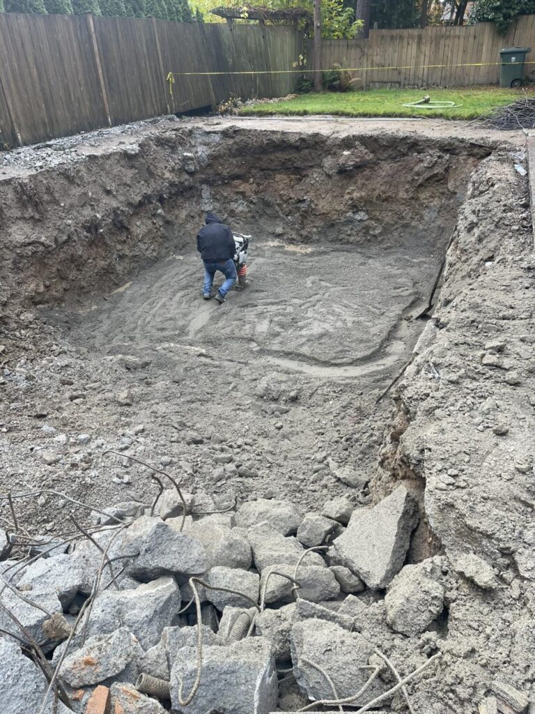 Half way mark of PNW Demolition demoing an in-ground pool in Snohomish County